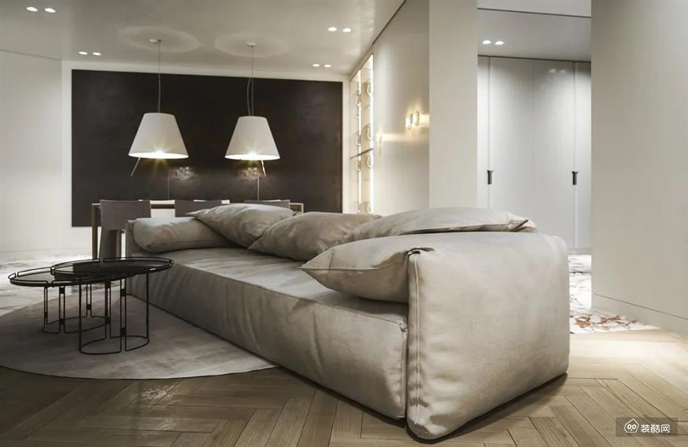 浅灰色的皮质沙发搭配圆形灰色地毯 营造出低调的高级感 两张高低不一的圆形茶几 与地毯形成呼应