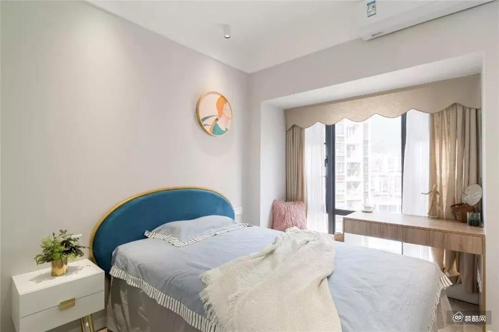 儿童房，蓝色的床头靠背，结合床头墙的圆形挂画，使得空间简洁又优雅温馨。。