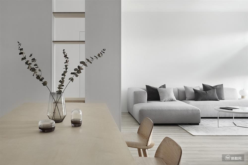 客厅以白色为主，拐角的布沙发与落地窗的搭配，增加空间的明亮感，